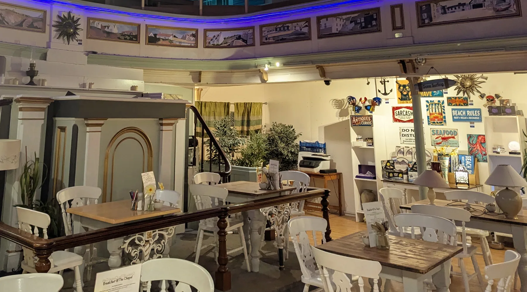 Inside The Chapel Cafe — the converted chapel nave with cakes, pews and dining tables